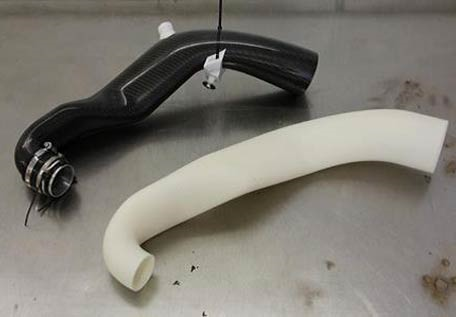 Composite turbo inlet duct (black) made using  Stratasys 3D printed FDM soluble core (white) 