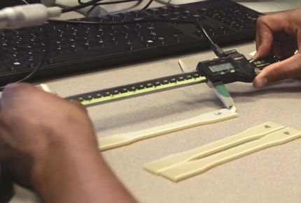 pair of hands working with heat treated FDM material