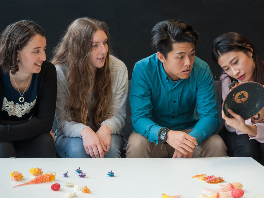 Students look at their 3d printed work. 