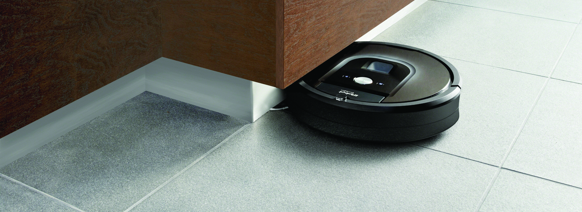 Roomba vacuum cleaner under counter top in kitchen