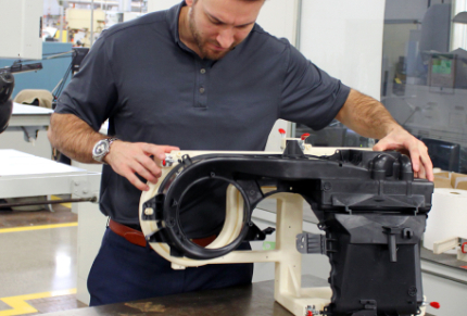 Man Stands at manufacturing tool