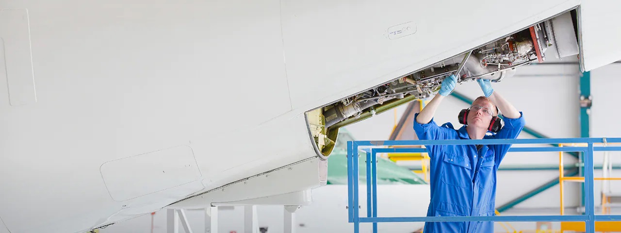 man working on airplane