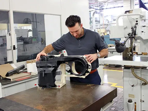 man working with trad 3d printed part