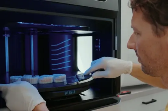 TrueDent 3D printed denture being removed from Stratasys J5 DentaJet