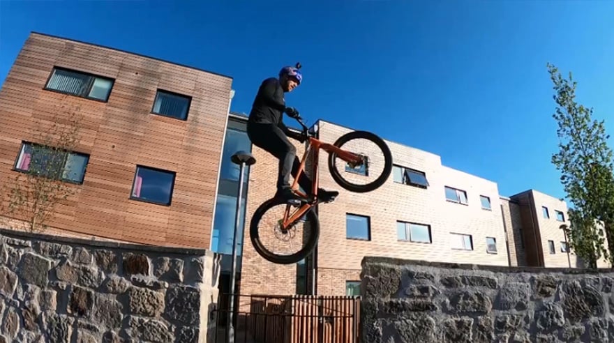 Danny MacAskill midair on his custom Santa Cruz bike.