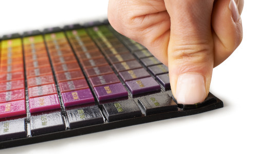 person pressing 3d printed color polyJet part | Stratasys Direct